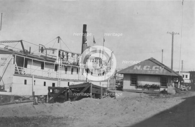 Boat docked at N.C. Co., between c1900 and 1916. Creator: Unknown.
