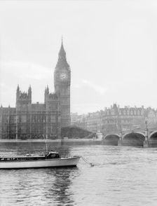 Boat passing along the Thames in front of Big Ben and the Houses of Parliament, London, c1955. Creator: Arthur Charles Kirby Ware