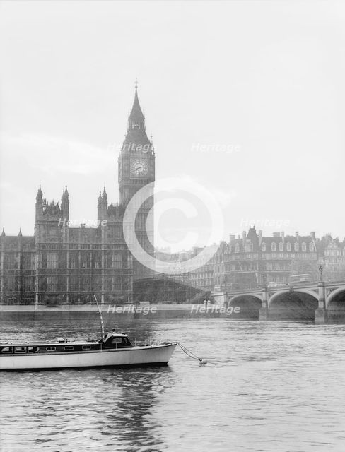 Boat passing along the Thames in front of Big Ben and the Houses of Parliament, London, c1955. Creator: Arthur Charles Kirby Ware.