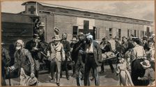 Boer War: wounded Boers are getting off a train, and one is being carried on a stretcher, 1900. Creator: George Soper