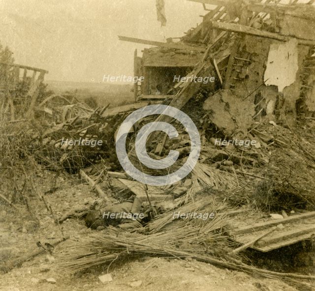 Bombed out building, body of dead soldier in foreground, 1916. Artist: Unknown.
