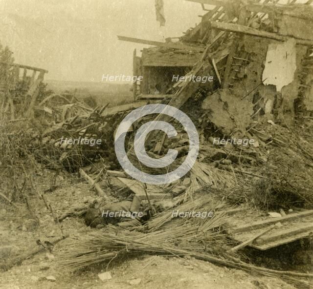 Bombed out building, body of dead soldier in foreground, 1916. Artist: Unknown.