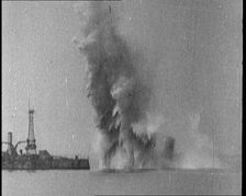 Bombs Dropped from Planes Exploding near a Warship, 1922. Creator: British Pathe Ltd