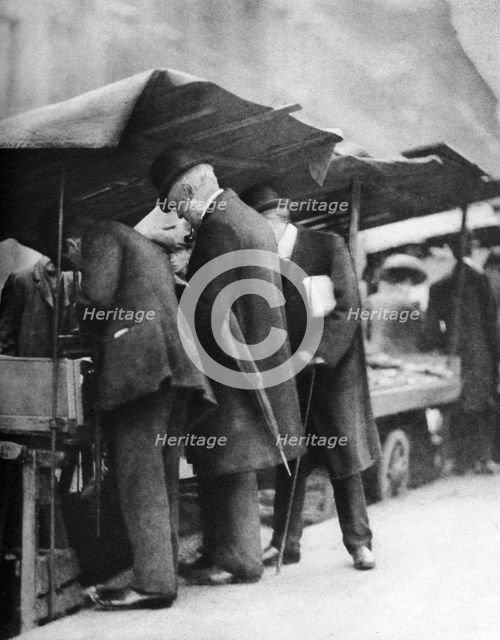 Bookstalls of the Farringdon Road market, London, 1926-1927.Artist: Walter Benington