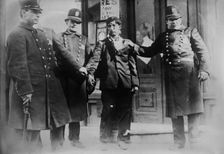 Battered striker with policemen, Philadelphia, 1910. Creator: Bain News Service