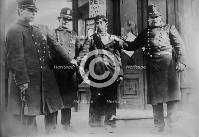 Battered striker with policemen, Philadelphia, 1910. Creator: Bain News Service.