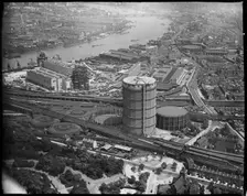 Battersea Power Station under construction and the Gas Holder Station, Nine Elms, London, c1930s. Creator: Arthur William Hobart