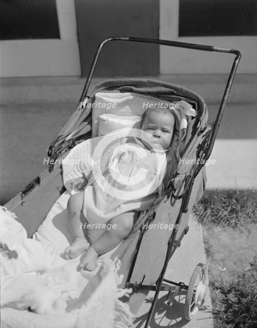 Baby taking a sun bath, Frederick Douglass housing project, Anacostia, D.C., 1942. Creator: Gordon Parks.