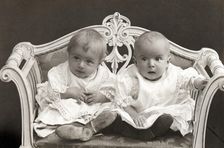 Baby twins on a small sofa