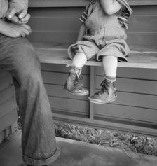 Baby with club feet wearing homemade splints, FSA camp, Tulare County, California, 1939. Creator: Dorothea Lange