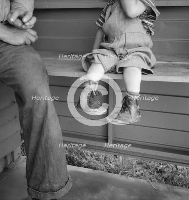 Baby with club feet wearing homemade splints, FSA camp, Tulare County, California, 1939. Creator: Dorothea Lange.