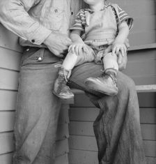 Baby with club feet wearing homemade splints, FSA camp, Tulare County, California, 1939. Creator: Dorothea Lange