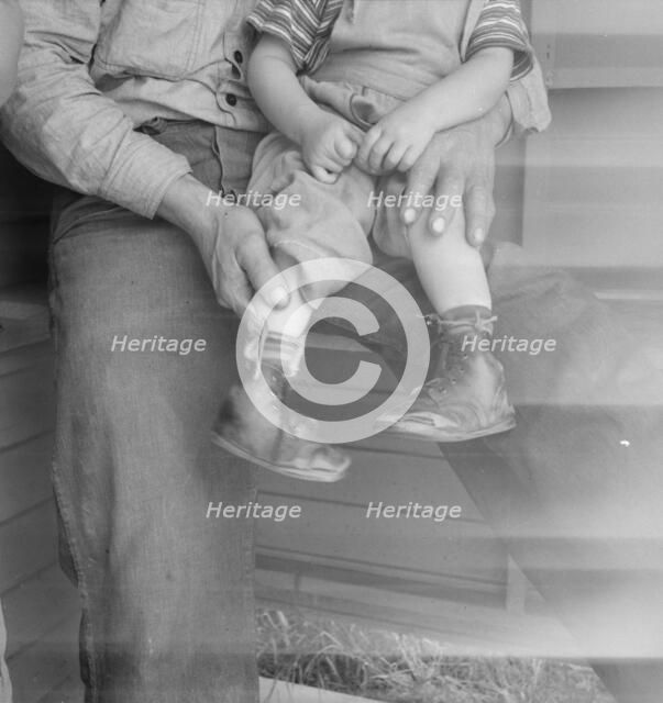 Baby with club feet wearing homemade splints, FSA camp, Tulare County, California, 1939. Creator: Dorothea Lange.