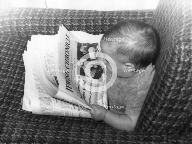 Baby Alex Feldman "reading" the "Jewish Chronicle", 1968. Creator: Unknown.
