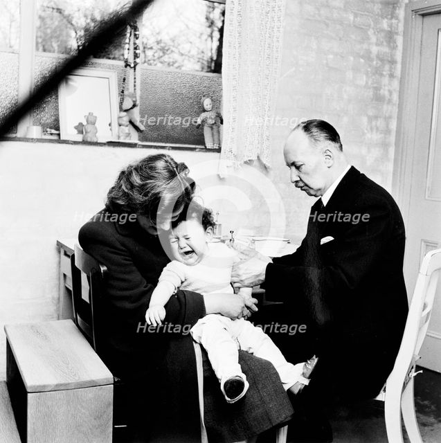 Baby being immunised, London, 1953. Creator: Henry Grant.