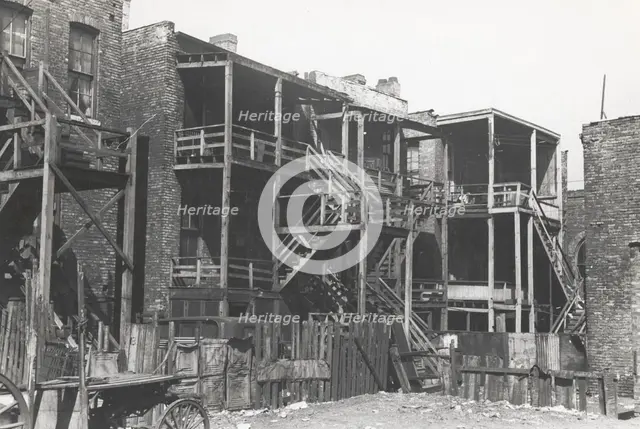 Back steps of apartments in Negro section of Chicago, Illinois, April 1941. Creators: Farm Security Administration, Russell Lee.