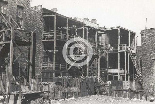 Back steps of apartments in Negro section of Chicago, Illinois, April 1941. Creators: Farm Security Administration, Russell Lee.