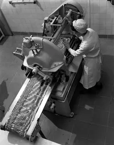 Bacon slicing machine, Danish Bacon Company, Selby, North Yorkshire, 1964. Creator: Michael Walters