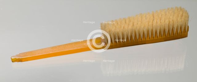 Bakelite clothes brush from dresser set owned by Lena Horne, mid 20th Century. Creator: Agalin.
