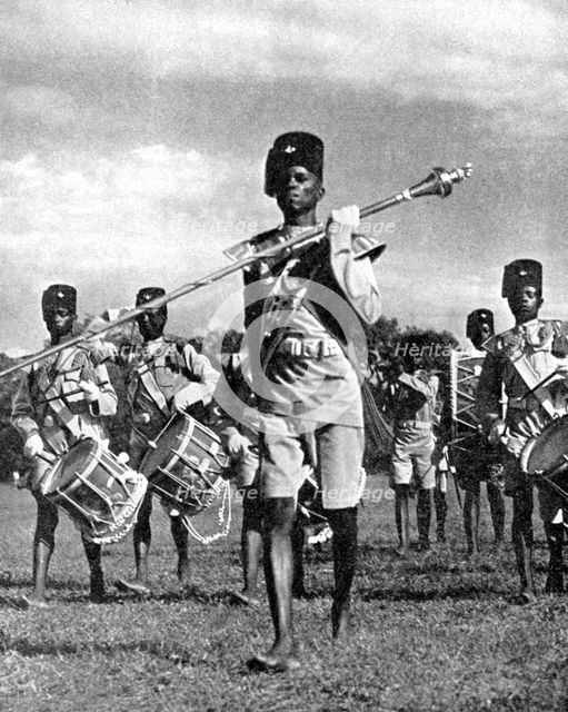 Bandsmen of the Northern Rhodesia Regiment beat a military tattoo, Zimbabwe, Africa, 1936.Artist: LNA Images