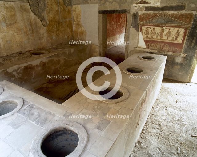 Bar counter with holes to place the amphorae, Thermopolium of Asellina, Pompeii, Italy (2002). Creator: LTL.