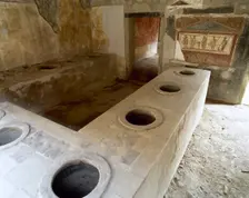 Bar counter with holes to place the amphorae, Thermopolium of Asellina, Pompeii, Italy (2002). Creator: LTL