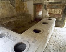Bar counter with holes to place the amphorae, Thermopolium of Asellina, Pompeii, Italy (2002). Creator: LTL