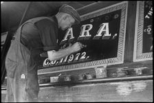 Barge painter Frank Jones, of 3 Edward Street, at work, Leighton Buzzard, Bedfordshire, 1910-60. Creator: George R Long