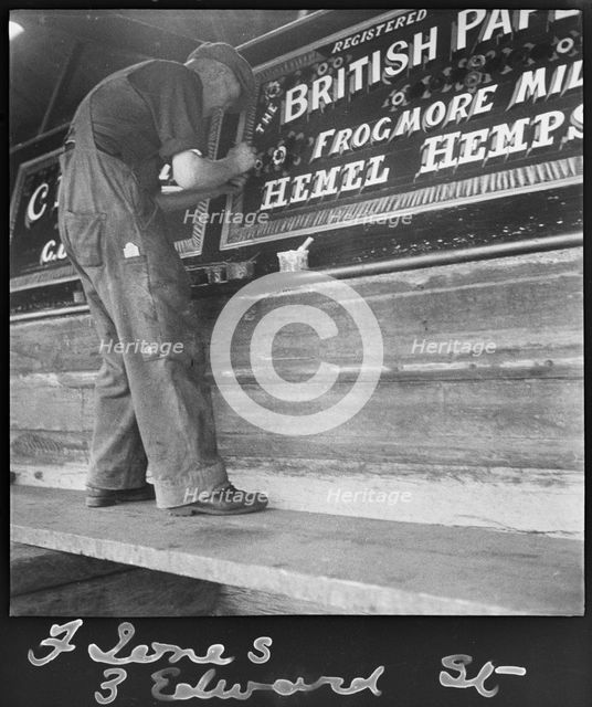 Barge painter Frank Jones, of 3 Edward Street, at work, Leighton Buzzard, Bedfordshire, 1910-60. Creator: George R Long.