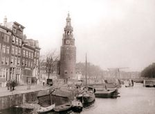 Barges on the canal in front of the Montelbaanstoren, Amsterdam, 1898.Artist: James Batkin