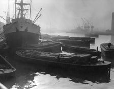 Barges and cargo ships on the River Thames, Pool of London, 1950s. Creator: Arthur Charles Kirby Ware