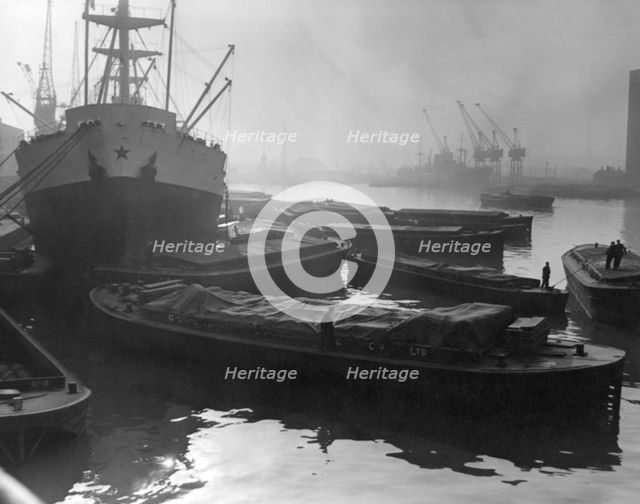 Barges and cargo ships on the River Thames, Pool of London, 1950s. Creator: Arthur Charles Kirby Ware.