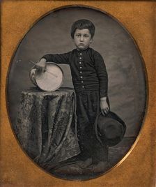 Barefoot Boy Holding Hat and Drum Stick, Leaning Forearm on Child-sized Drum on Table, 1850s. Creator: Unknown