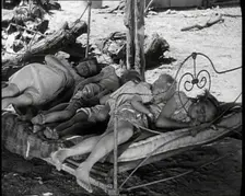 Barefoot Female Children Sleeping On a Bedframe Outside, 1932. Creator: British Pathe Ltd