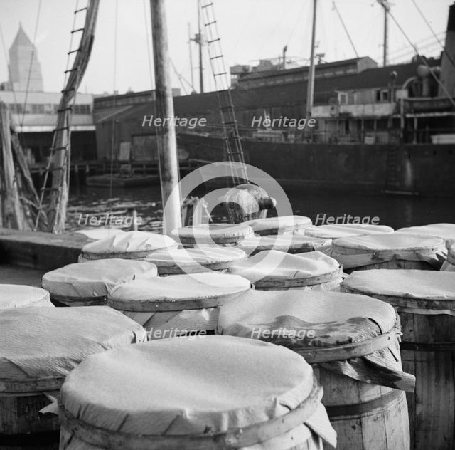 Barrels of fish on the docks at the Fulton fish market ready to be shipped to..., New York, 1943. Creator: Gordon Parks.