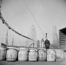 Barrels of fish on the docks at Fulton fish market ready to be shipped to..., New York, 1943. Creator: Gordon Parks