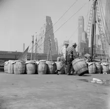 Barrels of fish on the docks at Fulton fish market ready to be shipped to retailers, New York, 1943. Creator: Gordon Parks