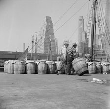 Barrels of fish on the docks at Fulton fish market ready to be shipped to retailers, New York, 1943. Creator: Gordon Parks