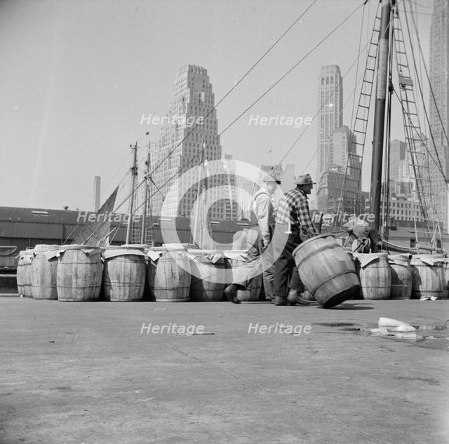 Barrels of fish on the docks at Fulton fish market ready to be shipped to retailers, New York, 1943. Creator: Gordon Parks.