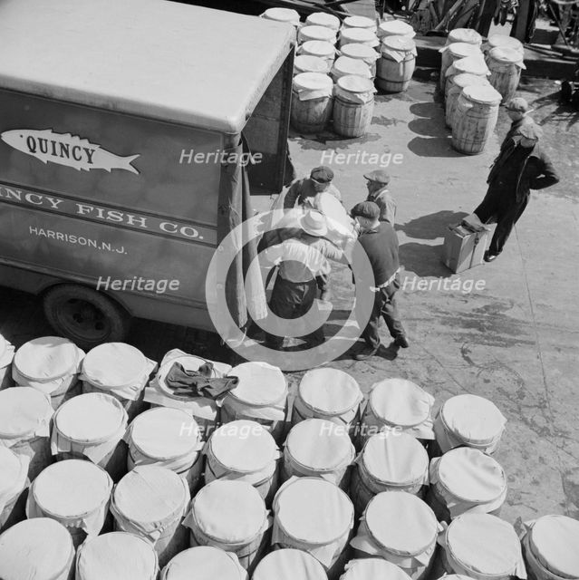 Barrels of fish on the docks at Fulton fish market ready to be shipped to retailers, New York, 1943. Creator: Gordon Parks.