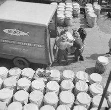 Barrels of fish on the docks at Fulton fish market ready to be shipped to retailers, New York, 1943. Creator: Gordon Parks