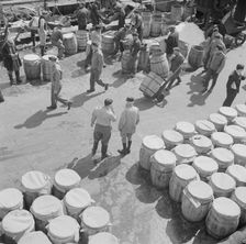 Barrels of fish on the docks at Fulton fish market ready to be shipped to retailers, New York, 1943. Creator: Gordon Parks
