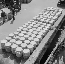 Barrels of fish on the docks at Fulton fish market ready to be shipped to retailers, New York, 1943. Creator: Gordon Parks