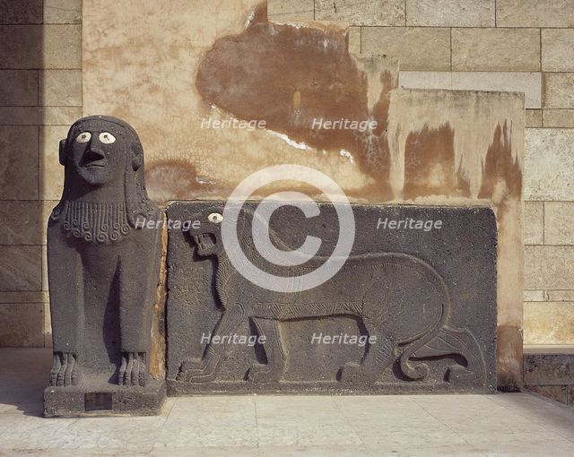 Basalt sphinx and a lion in relief, guarding the Temple of Tell Halaf, c6100 to 5400 BC. Creator: Unknown.