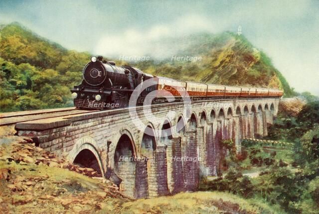 'Between Bombay and Delhi. A striking view of the Frontier Mail passing over a viaduct', 1935 Creator: Unknown.