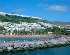 Beach and breakwater, Puerto Rico, Gran Canaria, Canary Islands. Creator: Peter Thompson