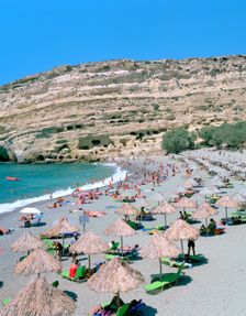 Beach and caves, Matala, Crete, Greece. Creator: Peter Thompson