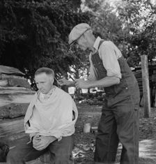 Bean pickers barber each other, near West Stayton, Marion County, Oregon, 1939. Creator: Dorothea Lange