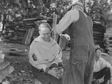 Bean pickers barbering each other, near West Staten, Marion County, Oregon, 1939. Creator: Dorothea Lange