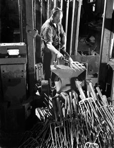 Beating hot garden forks, Ward & Payne Ltd, Sheffield, South Yorkshire, 1965. Creator: Michael Walters